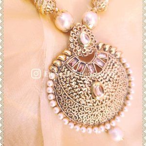 New faux pearl necklace with cut stones and ornate antique gold pendant